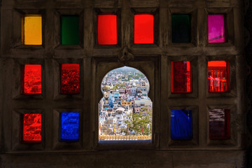 Town view from the colorful mosaic window in City Palace museum of Udaipur, Rajasthan, India - 194676479
