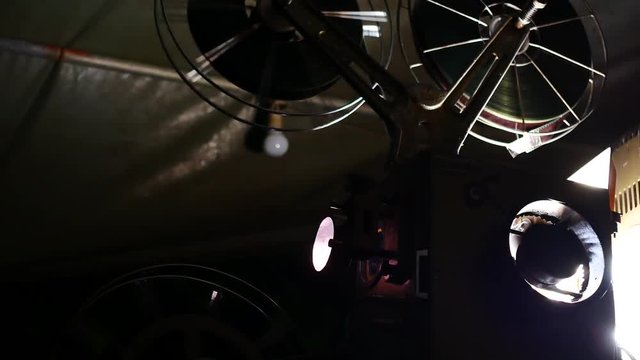 Close up  Film Roll is spinning while projecting In the movie theater in 4k or UHD Resolution.