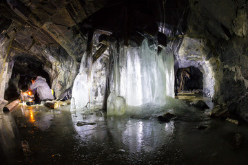 Frozen waterfall in a stone cave