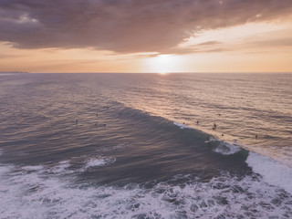 drone view of a surfer in the sunset