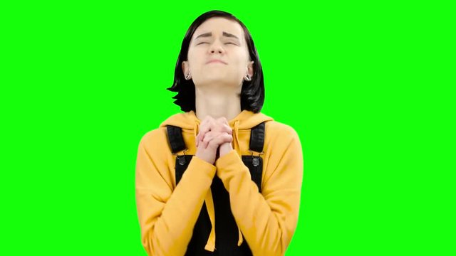 Teenager crossed her fingers in the hope of good grades. Green screen