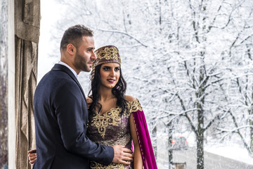 Happy couple in traditional turkish wedding dress during their wedding
