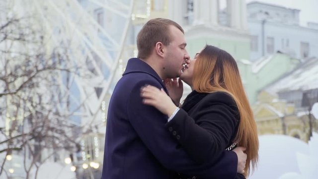 Happy beautiful couple kisses and celebrates engagement