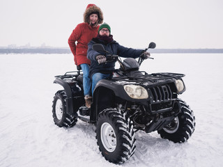 People in atv quad bike. Winter snow field