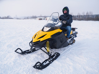 Fototapeta na wymiar Man in the snowmobile. Winter snow field