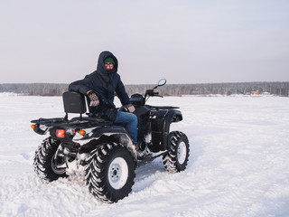 Man in atv quad bike. Winter snow field © paulzhuk
