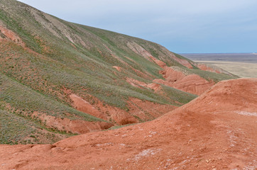 red sandstone outcrops on the slopes of Big Bogdo sacred mountain in Caspian steppe...