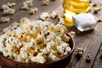 Air salty popcorn.A bowl of popcorn on a wooden table.Salt popcorn on the wooden background .  With space for text.Top view.popcorn texture.Chees .