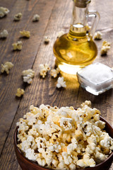 Air salty popcorn.A bowl of popcorn on a wooden table.Salt popcorn on the wooden background .  With space for text.Top view.popcorn texture.Chees .