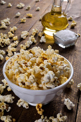 Air salty popcorn.A bowl of popcorn on a wooden table.Salt popcorn on the wooden background .  With space for text.Top view.popcorn texture.Chees .