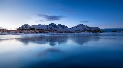 Mountain ridge and reflection in the lake. Natural landscape in the Norway