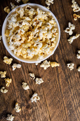 Air salty popcorn.A bowl of popcorn on a wooden table.Salt popcorn on the wooden background .  With space for text.Top view.popcorn texture.Chees .