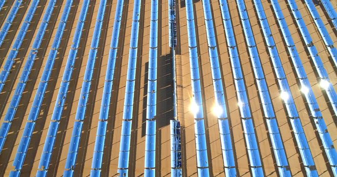 Aerial view of a solar or sun farm producing clean renewable photovoltaic energy. Industrial landscape. 4K