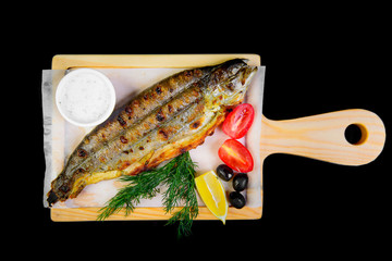 grilled fish on a black background