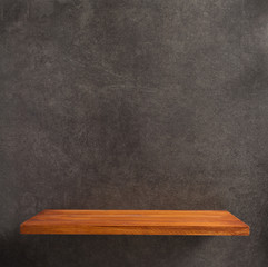 wooden shelf at concrete wall