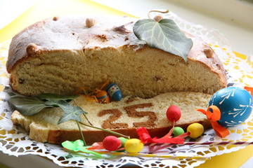 Home made Easter Cake with number 25 and one big blue Egg, several small eggs and ivy leaves overall view
