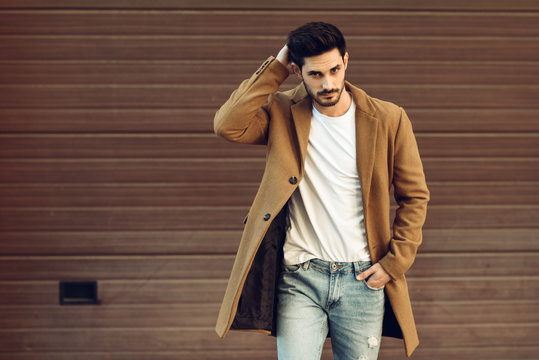 Young Man Wearing Winter Clothes In The Street.