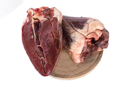 Beef heart cut in half on a cutting Board. isolate on white background. Copy paste