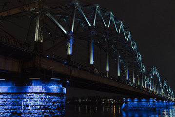 Night railway bridge with blue lights. Riga Latvia