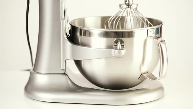 Close up of silver food electric mixer on a white background