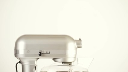 Close up of silver food electric mixer on a white background
