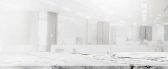Empty white marble stone tabletop and blurred bokeh office interior space banner background - can used for display or montage your products.
