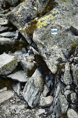 a stone mountain walkway with a tourist sign