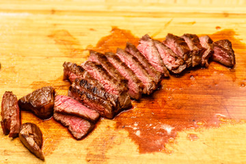 The chef cuts beef steak roasting rare.