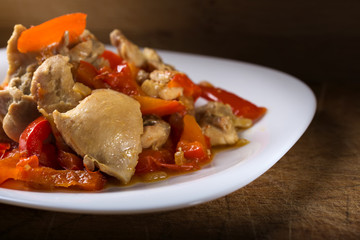 Plate with chicken stew with red pepper