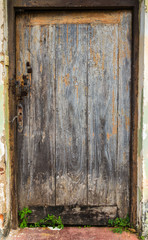 Old wooden brown house door vintage wood background texture with knots and nail holes