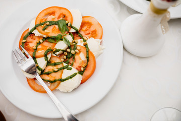 Caprese salad made of mozzarella cheese, tomatoes and basil