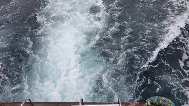 Boating on sea, water turbulence above back ship motor