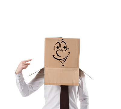 cheerful businessman pointing on cardboard box on his head isolated on white