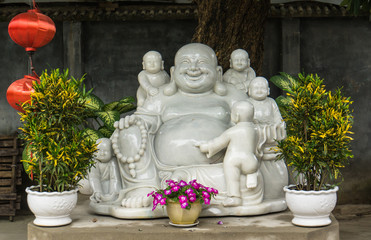 white statue of the Happy Buddha