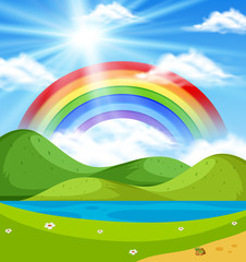 Nature scene with rainbow over the hills