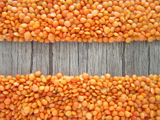 red lentils on a wooden floor.food,grains,cereals.
