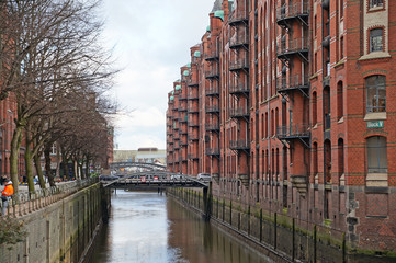 
Speicherstadt. Port warehouse in Hamburg. Hamburg is a harsh German city. The urban landscape of northern Germany. View of city canals from the bridge.