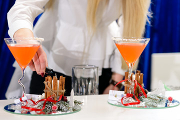 Unknown bartender preparing Christmas alcoholic cocktail, shallow dof