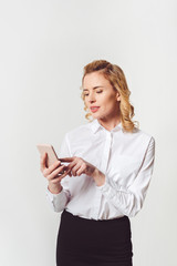 Fototapeta premium stylish adult businesswoman using smartphone on white