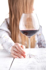Young woman with a glass of wine. Addicted to drugs and alcohol.