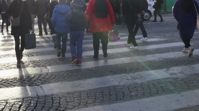 Crowd of people crossing road on pedestrian, traffic rules compliance, Paris