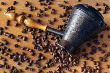 natural, aromatic, not crushed coffee from the tsezh poured on a wooden surface
