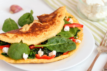 Omelet with spinach, ricotta cheese and red pepper.