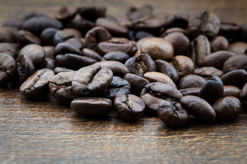 Coffee grains, close-up on a textural background in the form of a tree.
