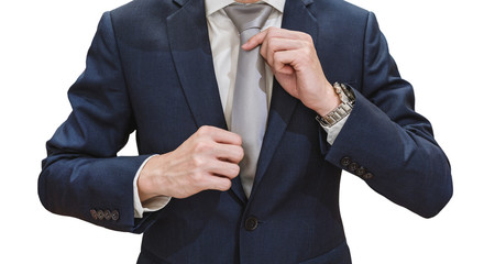 Young businessman in blue suit touching necktie, isolated on white background