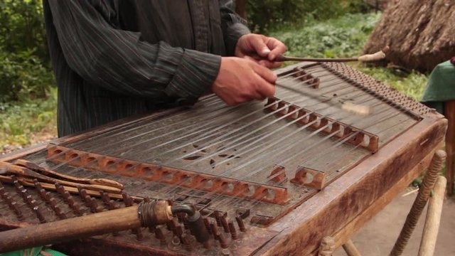 Playing the dulcimer folk musical instrument from Europe