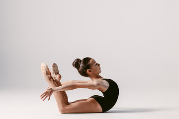 Young gymnast girl stretching and training