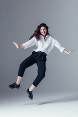 Young beautiful female dancer is posing in the studio