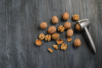 Walnut kernels and whole walnuts on rustic old wooden table