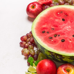Watermelon and various fruits on white background
